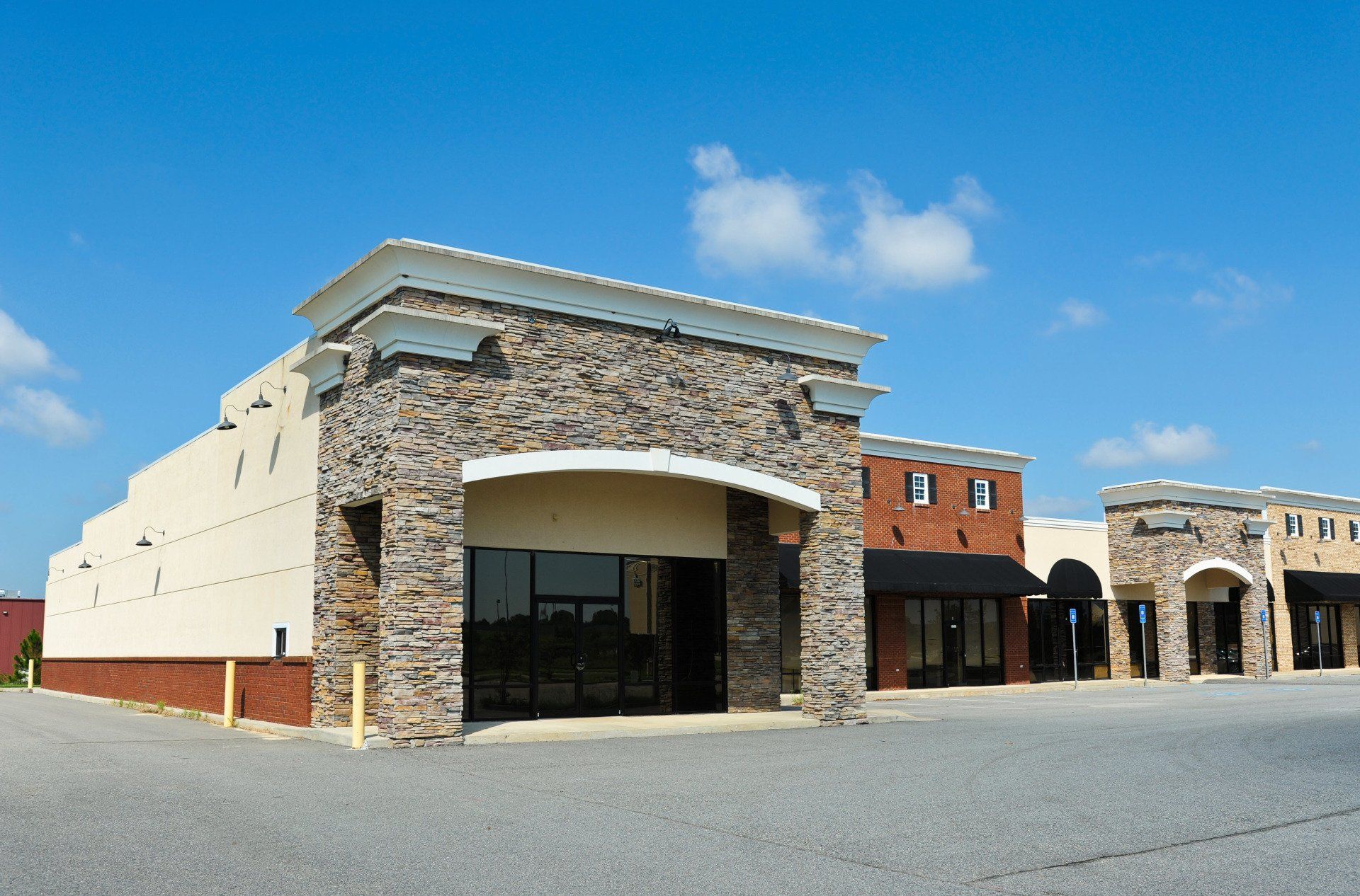 A building with a stone facade and a blue sky in the background