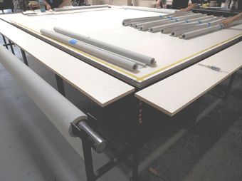 Roller shade making table at The Roman Shades roller shade factory in Rialto, CA