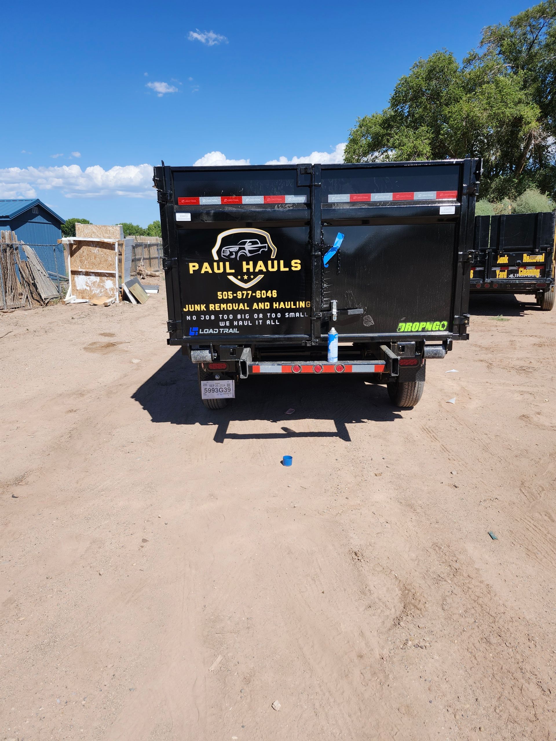 A dumpster with paul habla written on it