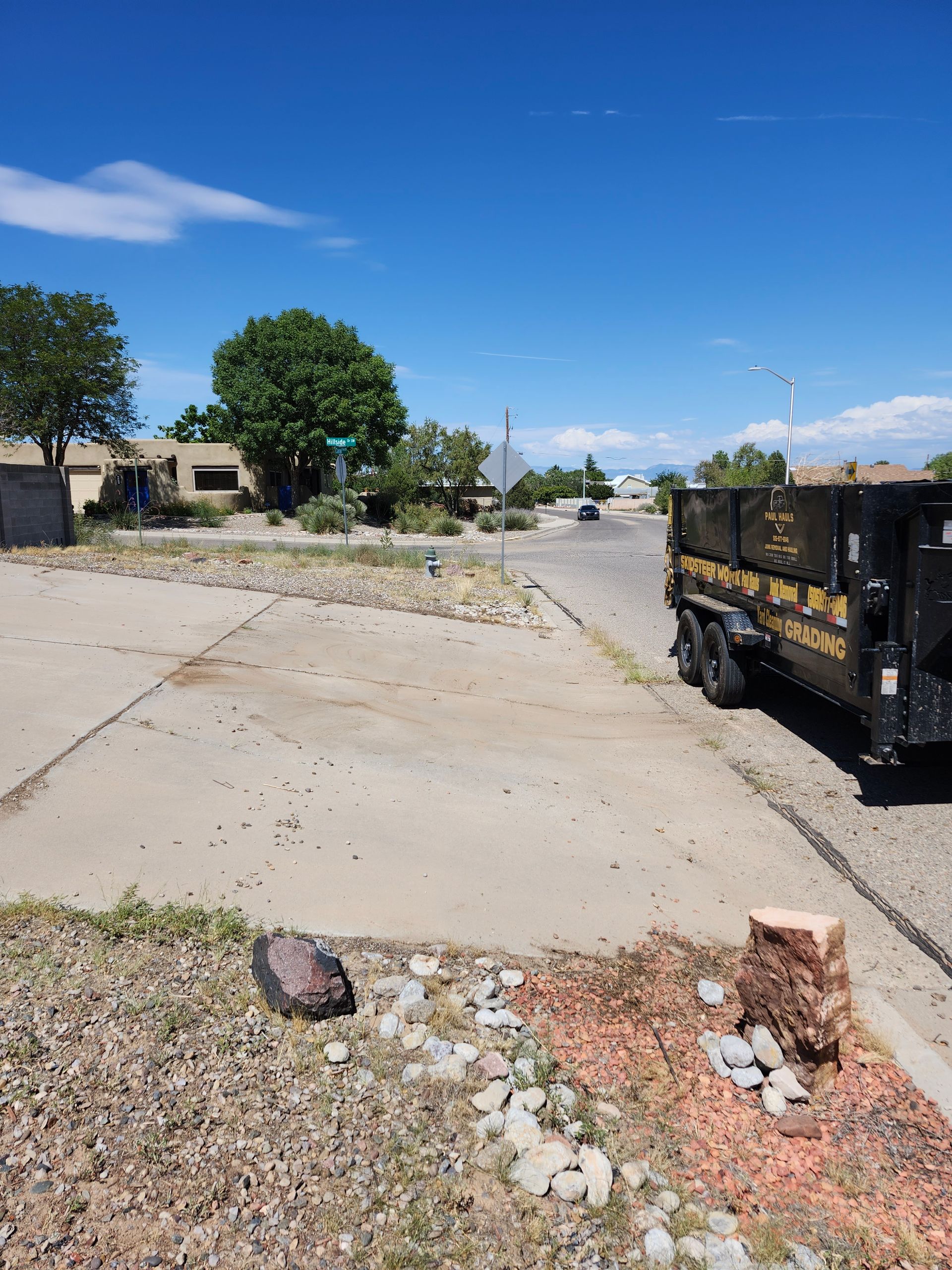 A dump truck is parked on the side of the road.