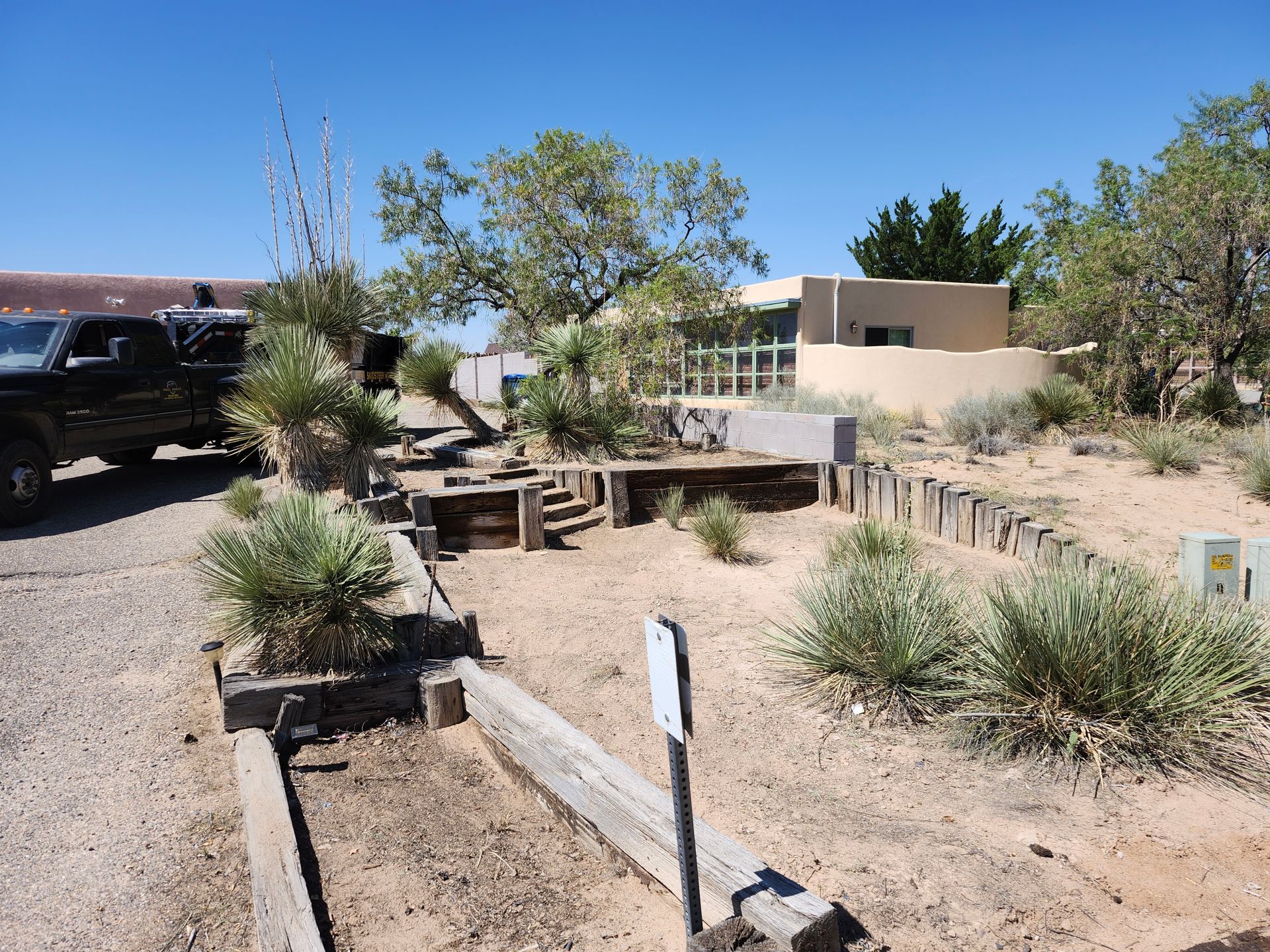 A truck is parked on the side of the road in the desert