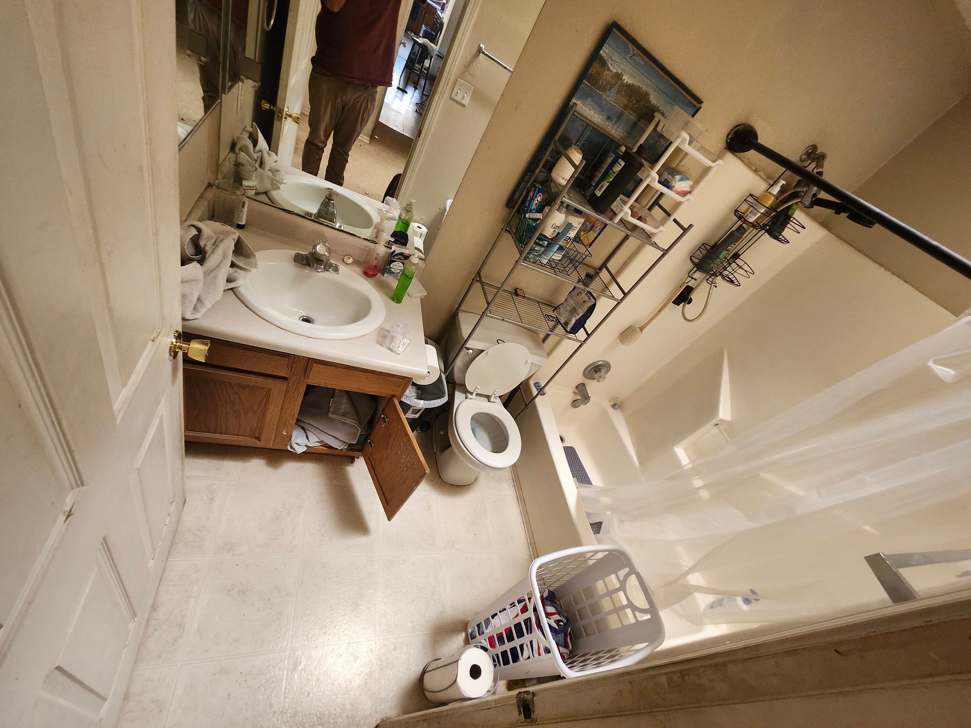 A bathroom with a sink a toilet and a bathtub