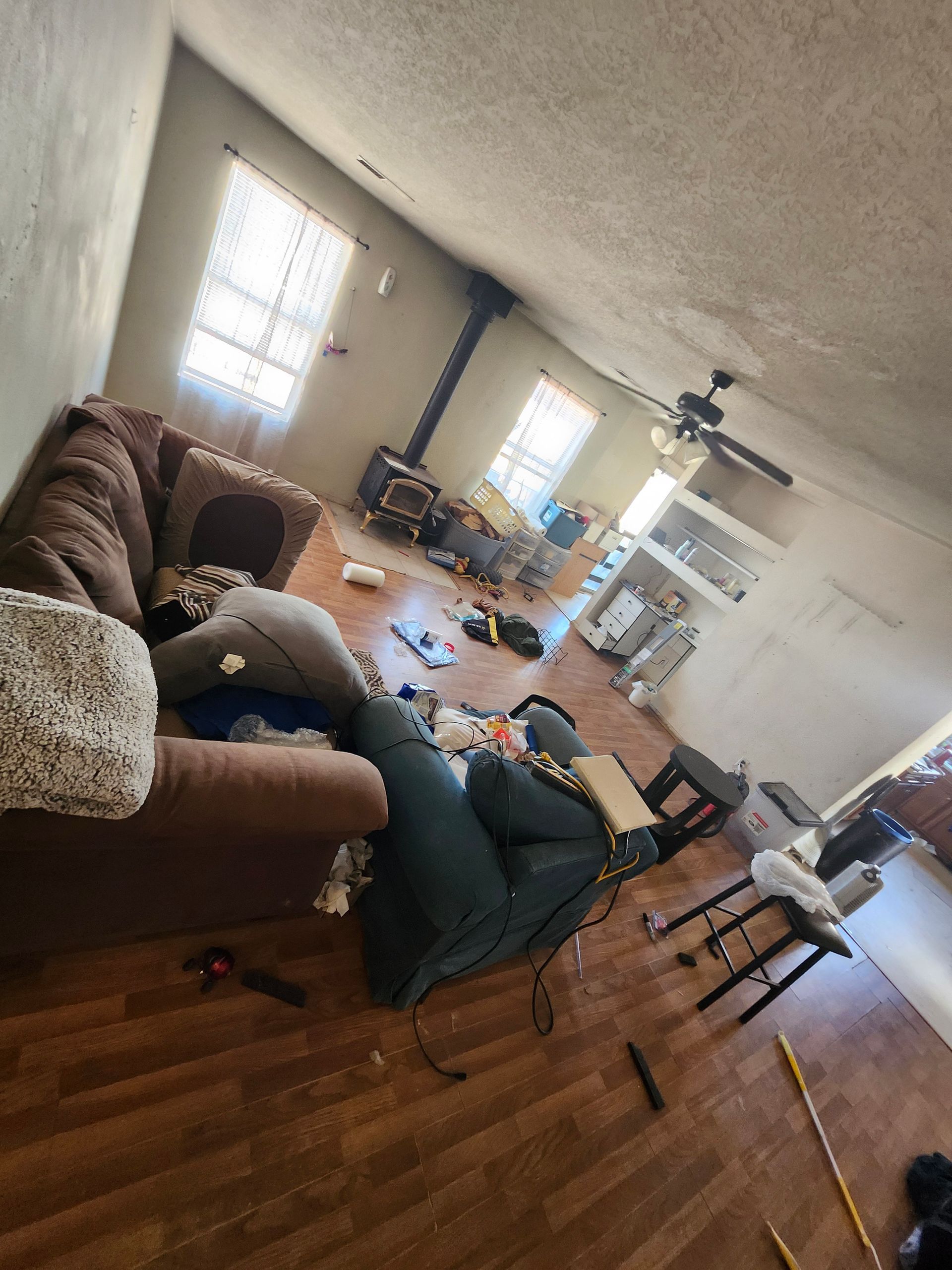 A living room filled with furniture and a ceiling fan.