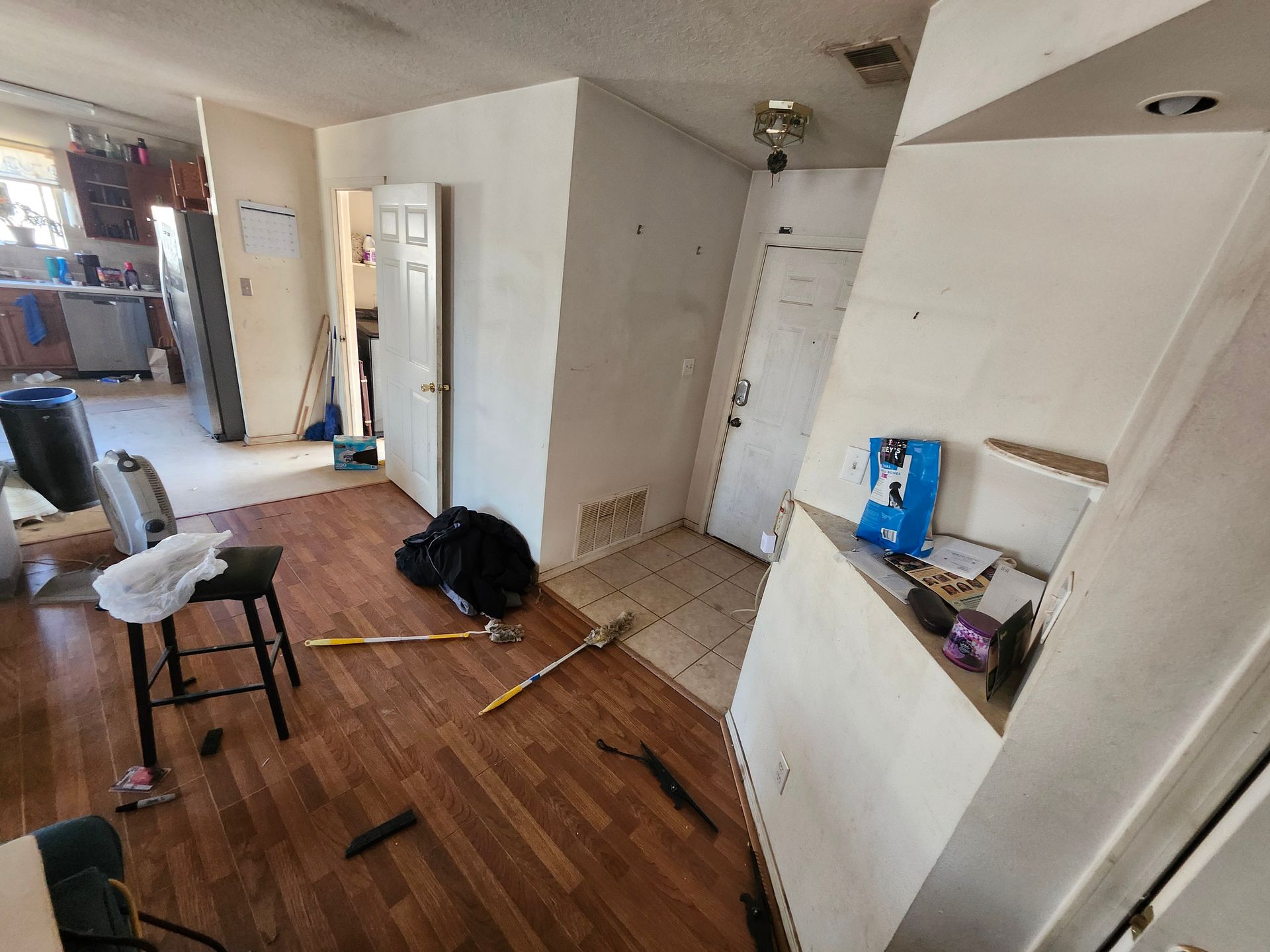 A living room with wooden floors and white walls.
