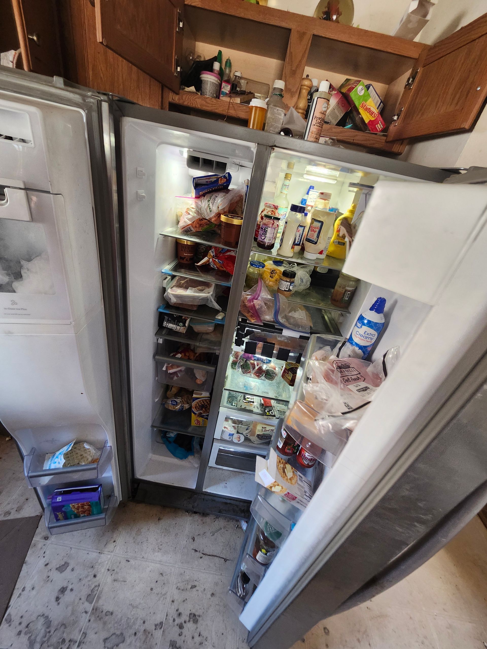 An open refrigerator filled with lots of food and drinks