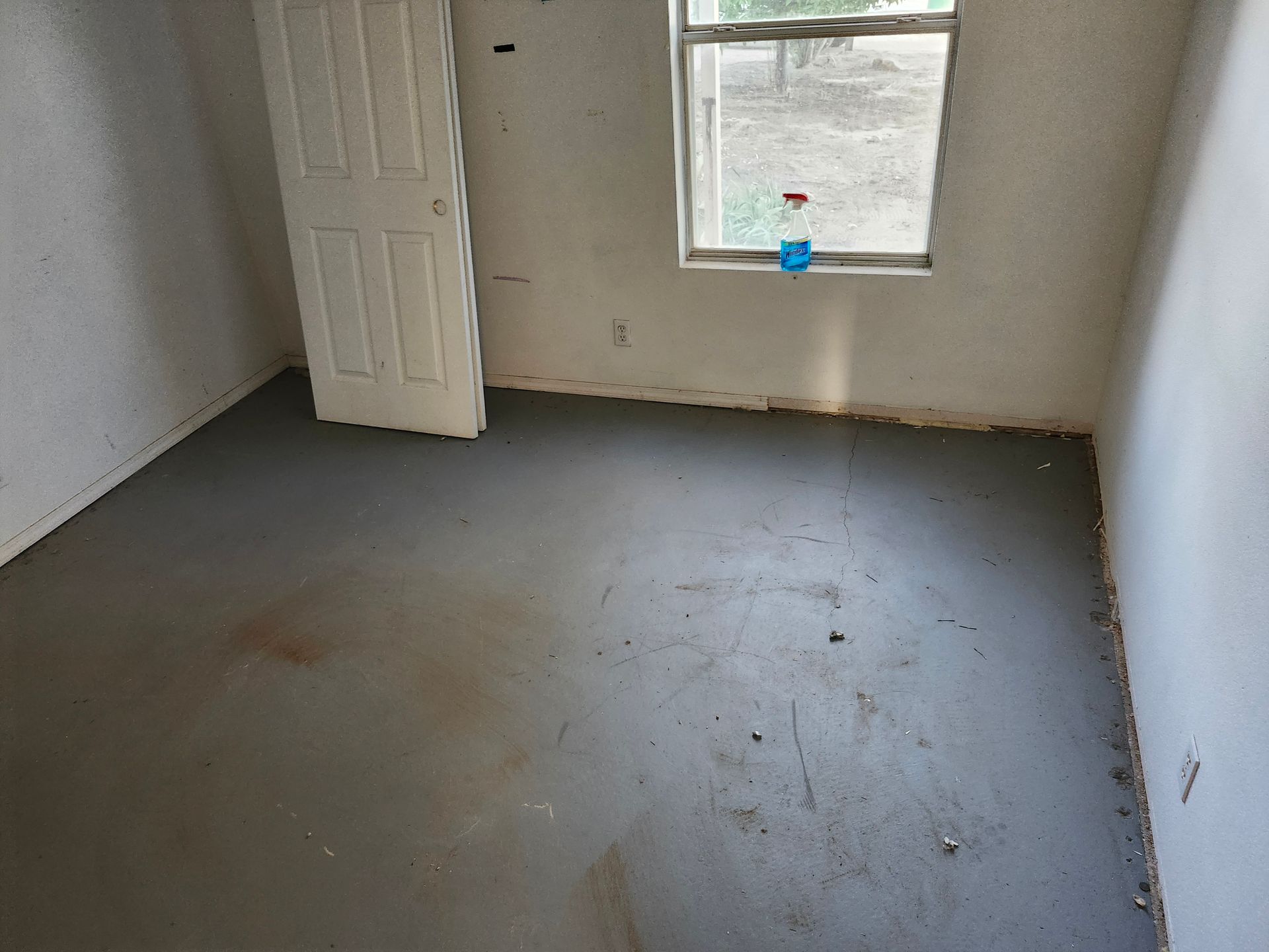 An empty room with a window and a door