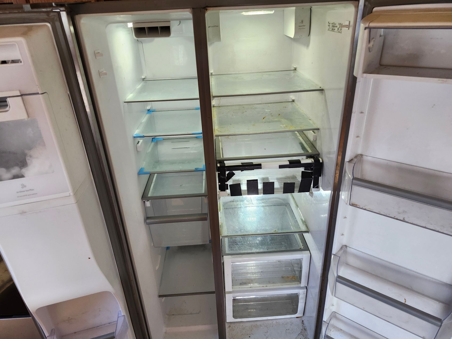 The inside of an empty refrigerator with the door open