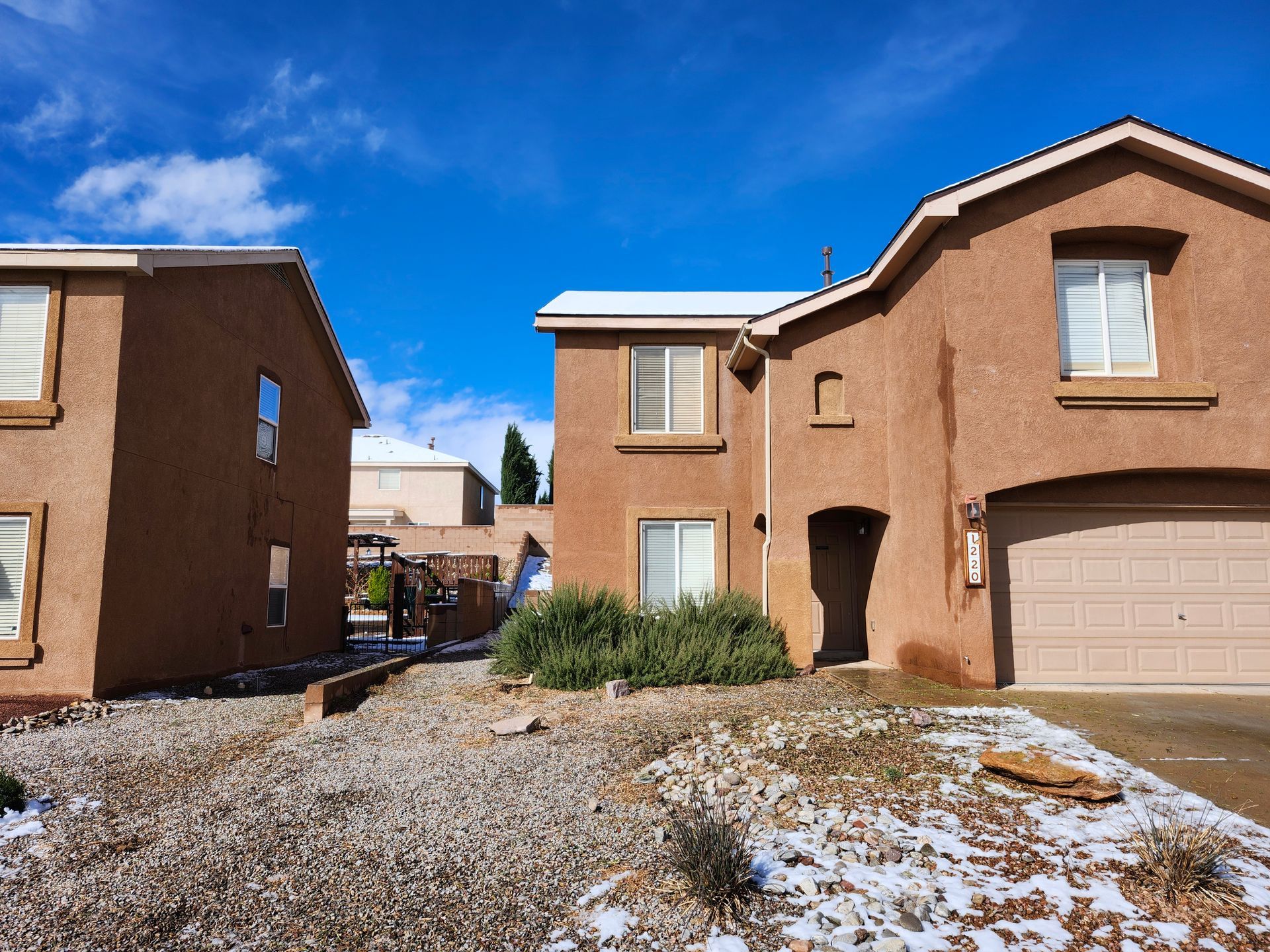 Two houses are sitting next to each other on a sunny day.