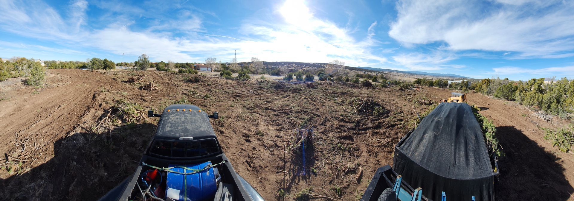 A person is riding a buggy down a dirt road.