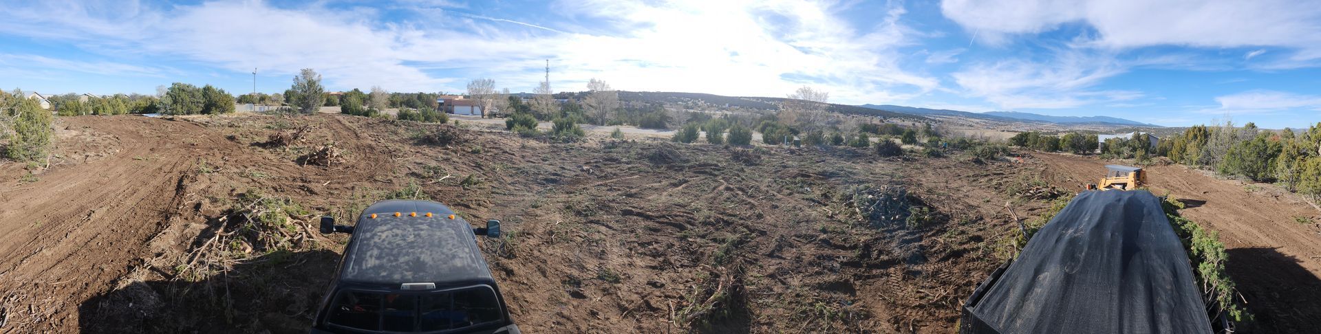 A person is riding a bike on a dirt road in a field.