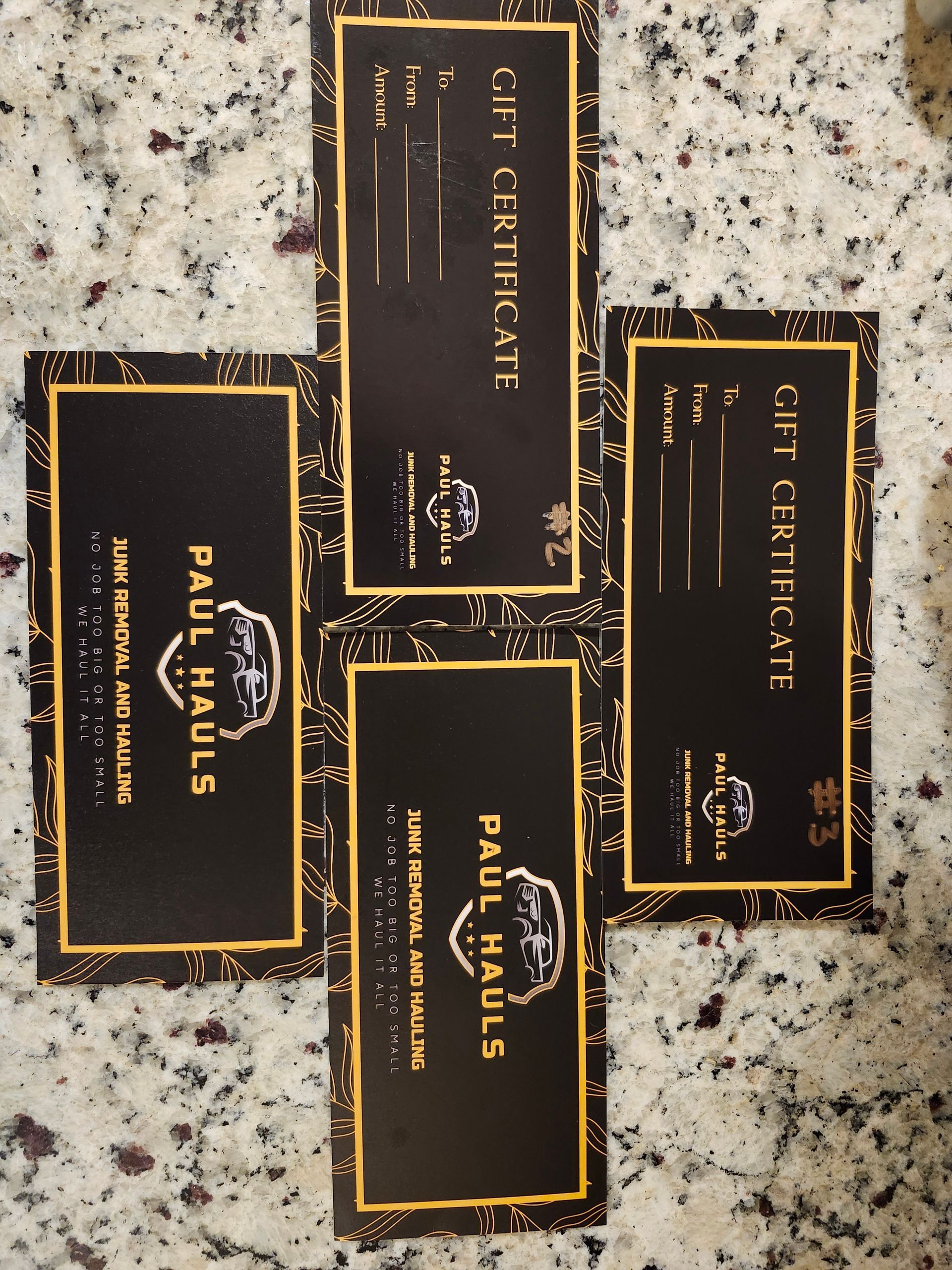 A gift certificate for paul hauls sits on a counter