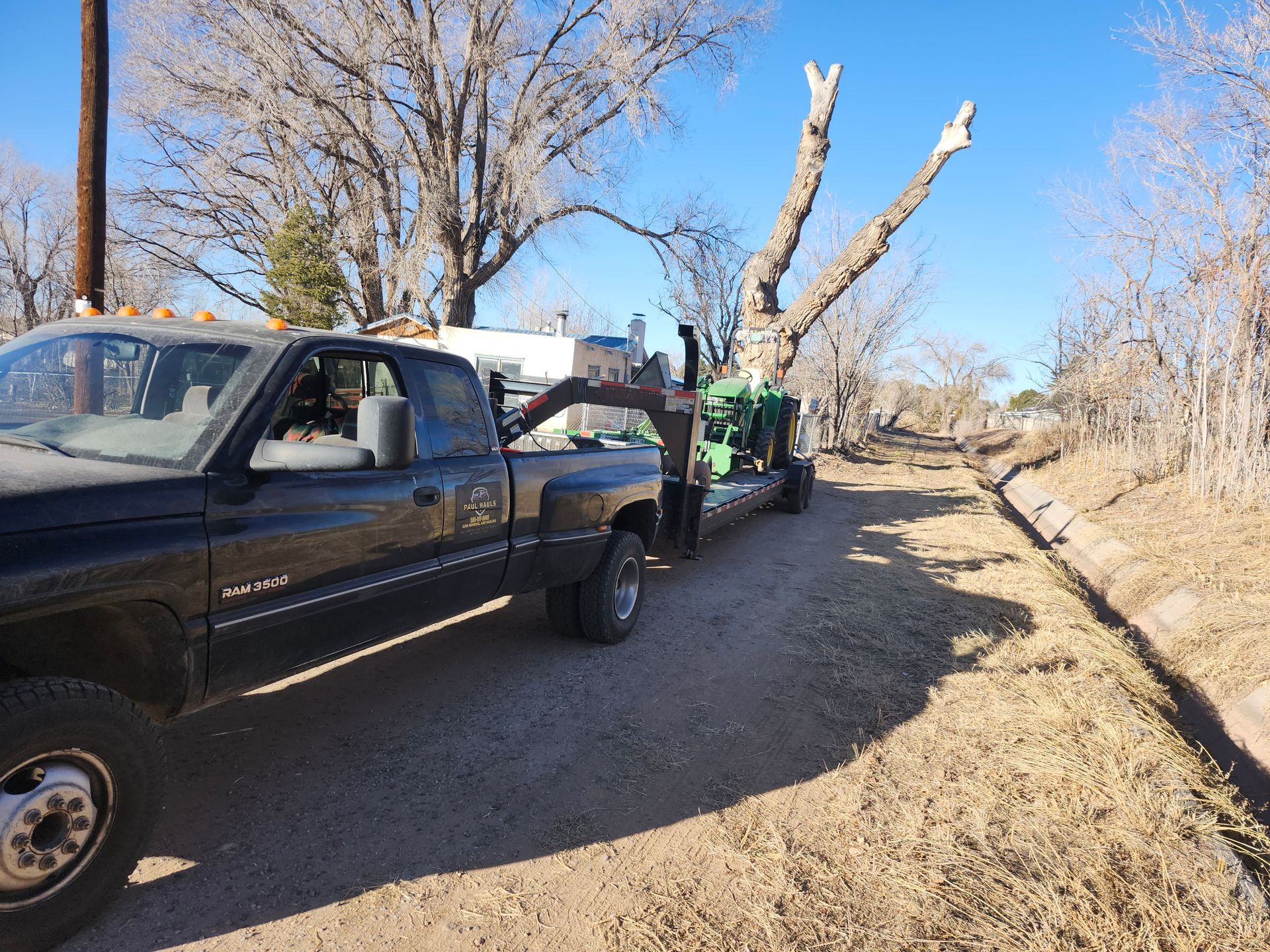 A truck is towing a trailer with a tree on it