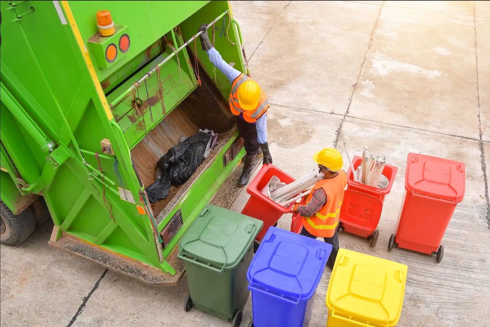 A metal dumpster filled with broken bricks. The dumpster is outdoors in a brightly lit environment.