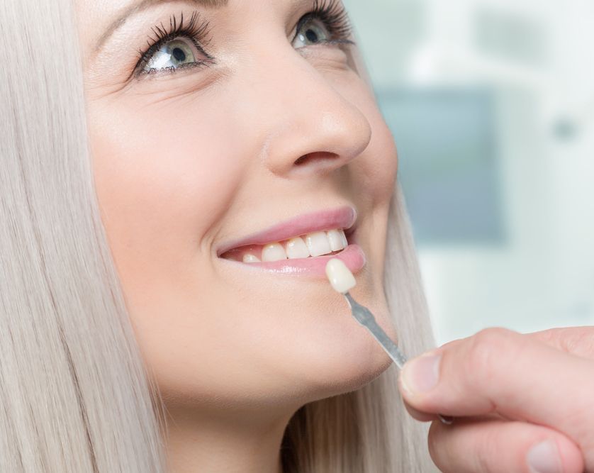 A Woman is Getting Her Teeth Examined by a Dentist — Cairns Precision Dental Group In Woree, QLD