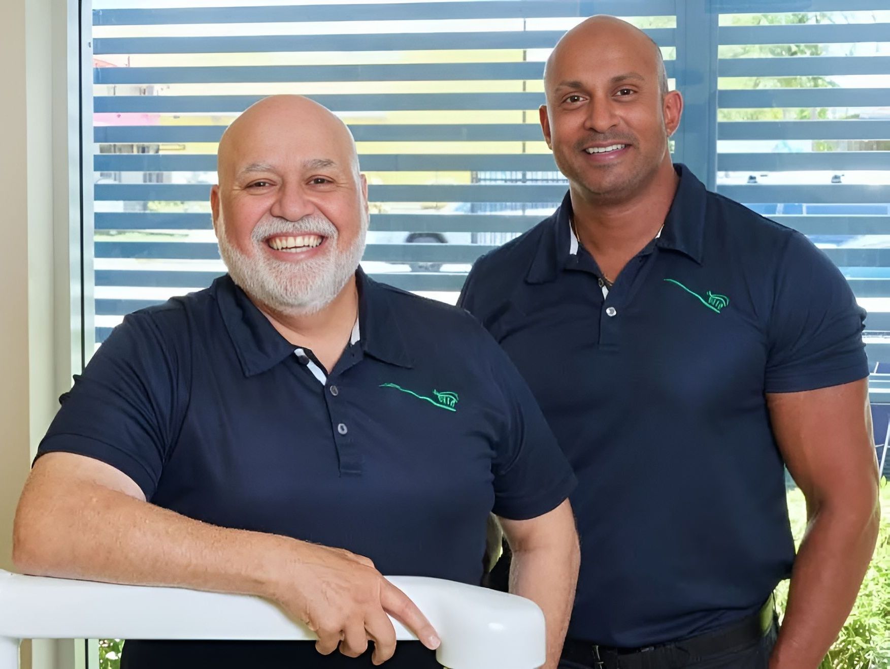 Two Men Are Posing For A Picture In Front Of A Window — Cairns Precision Dental Group In Woree, QLD