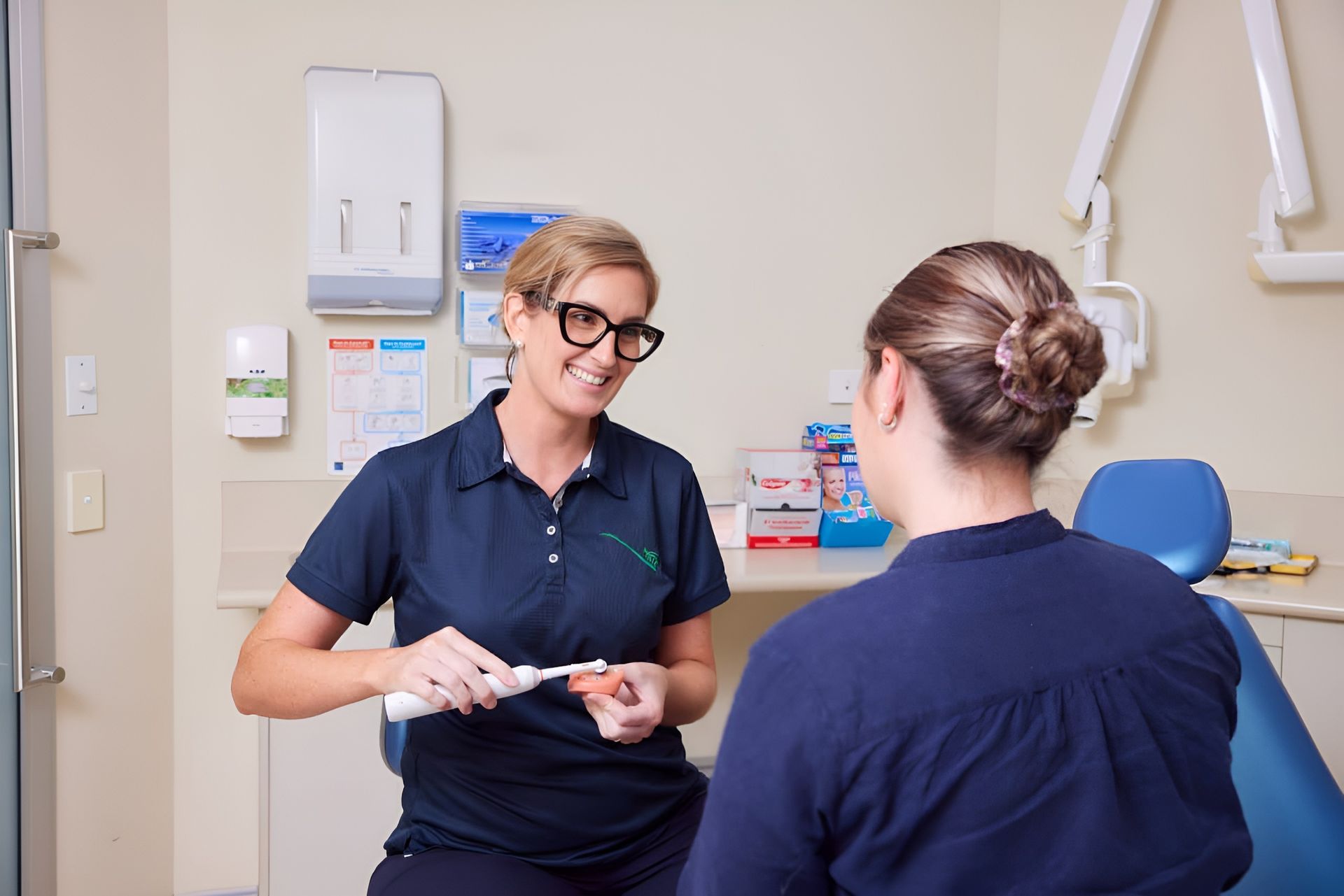 A Man and a Woman Are Standing Next to Each Other in a Dental Office — Cairns Precision Dental Group In Woree, QLD