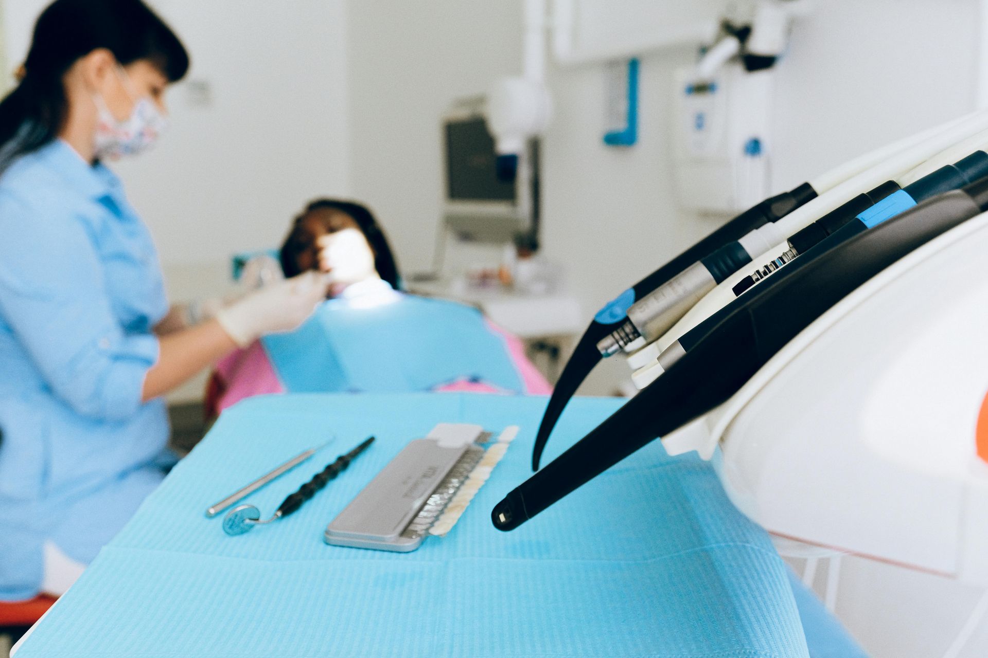 A Dentist Is Examining A Patient 's Teeth In A Dental Office — Cairns Precision Dental Group In Wore