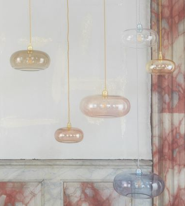 Eine Gruppe von Pendelleuchten, die in einem Raum von der Decke hängen.