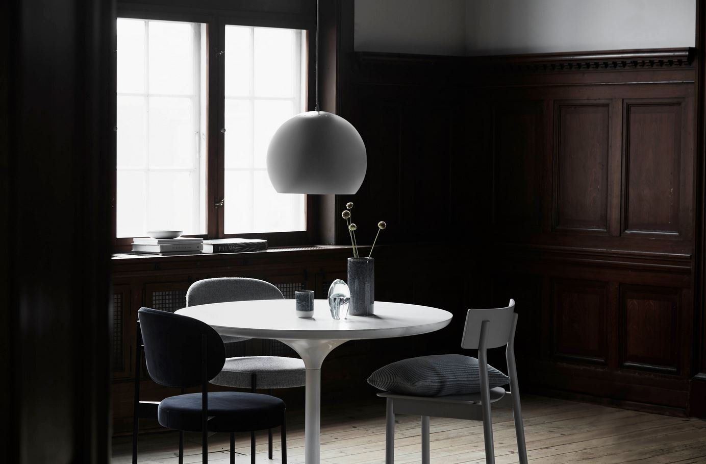 Ein Esszimmer mit Tisch und Stühlen und einem Fenster