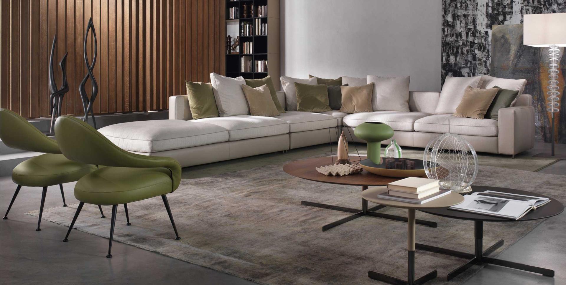 Ein Wohnzimmer mit einem großen Sofa und grünen Stühlen