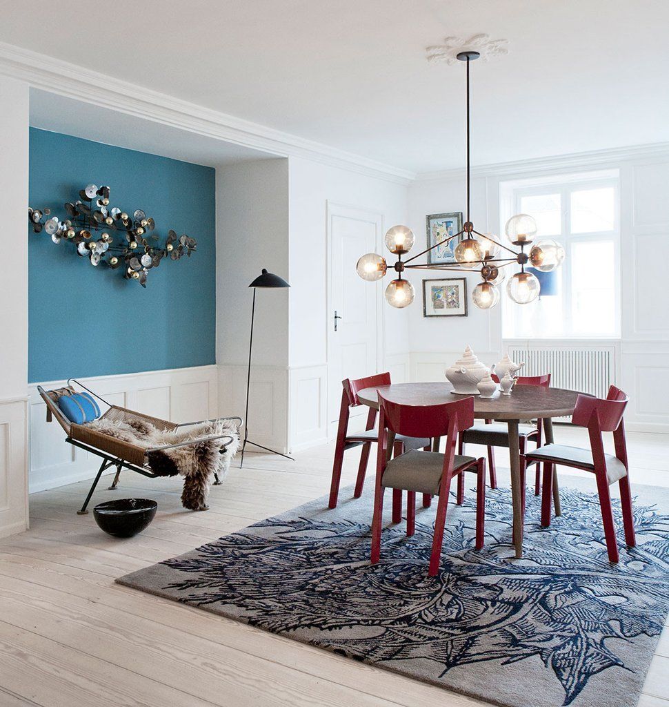 Ein Esszimmer mit Tisch und Stühlen und einem Teppich