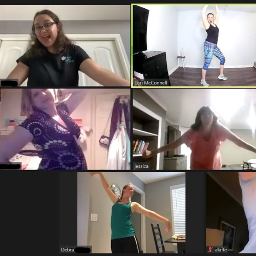 People in a video conference doing dance exercises with arms up; screen shows faces of participants.