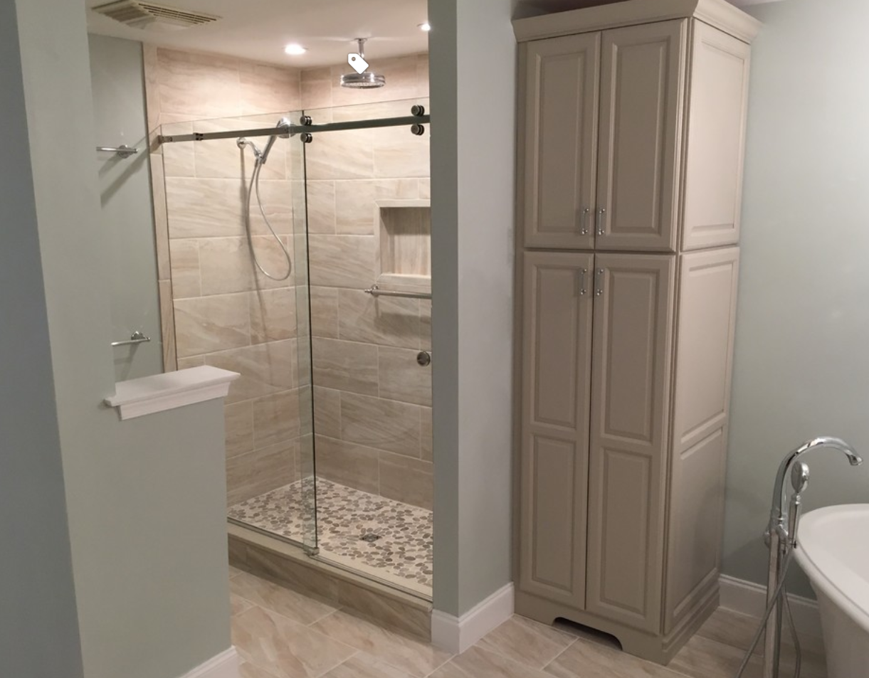 A bathroom with a walk in shower and a bathtub.