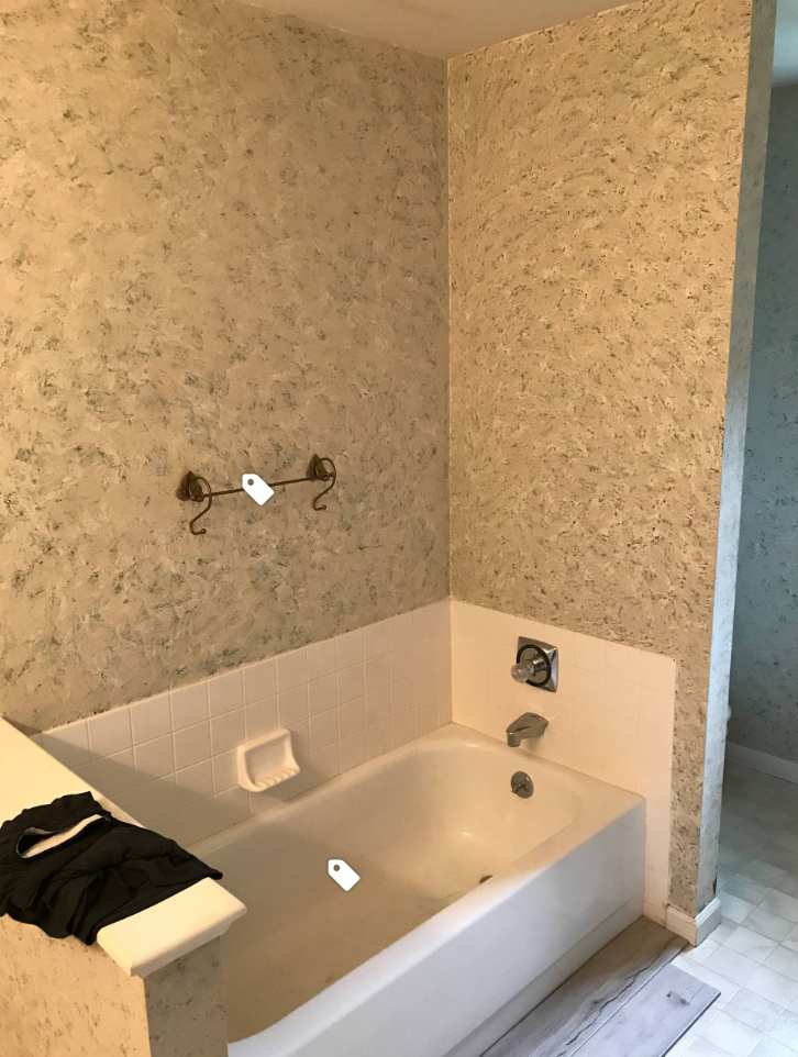 A bathroom with a bathtub and a shower.