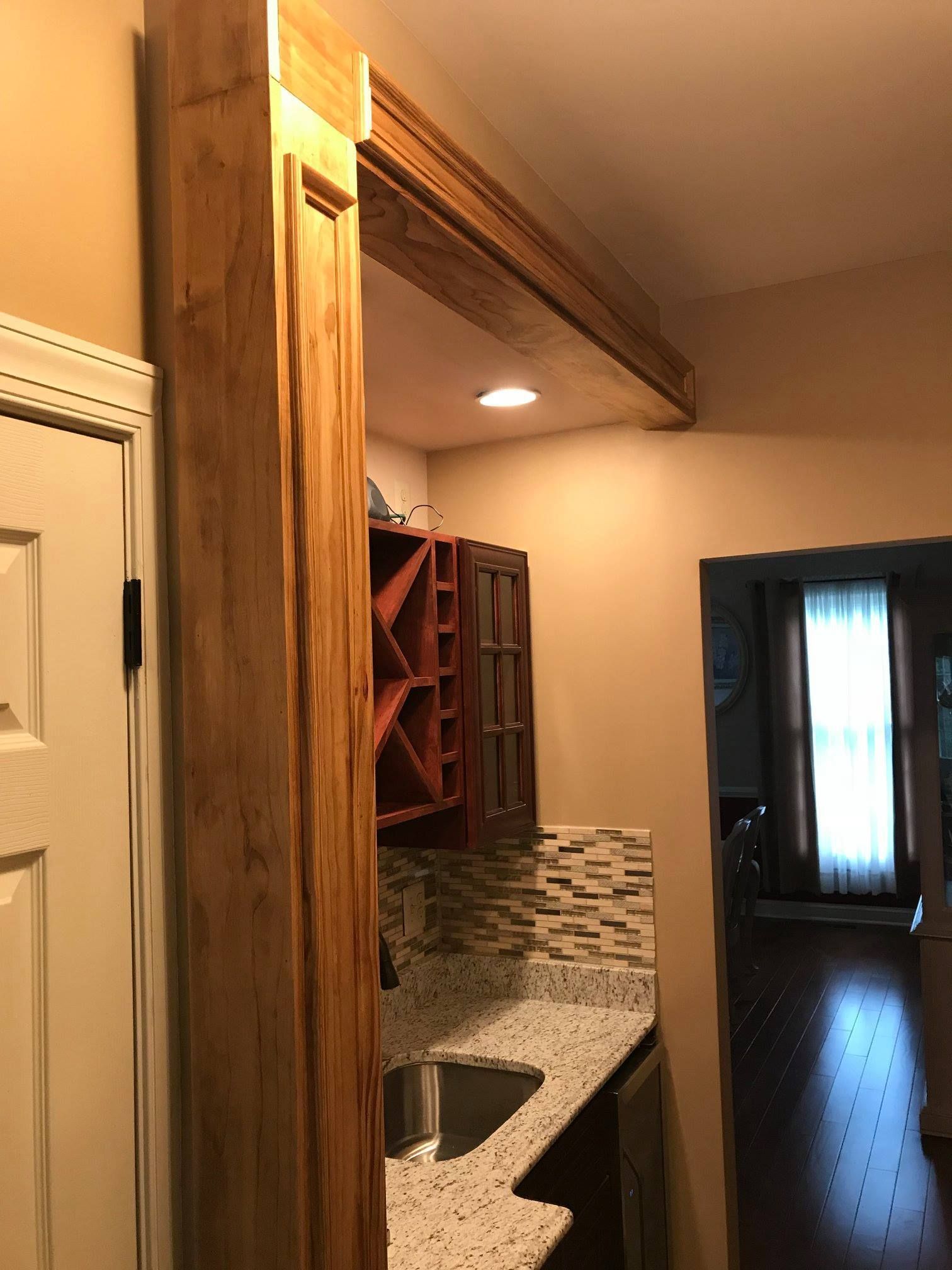 A kitchen with a sink and a wine rack.