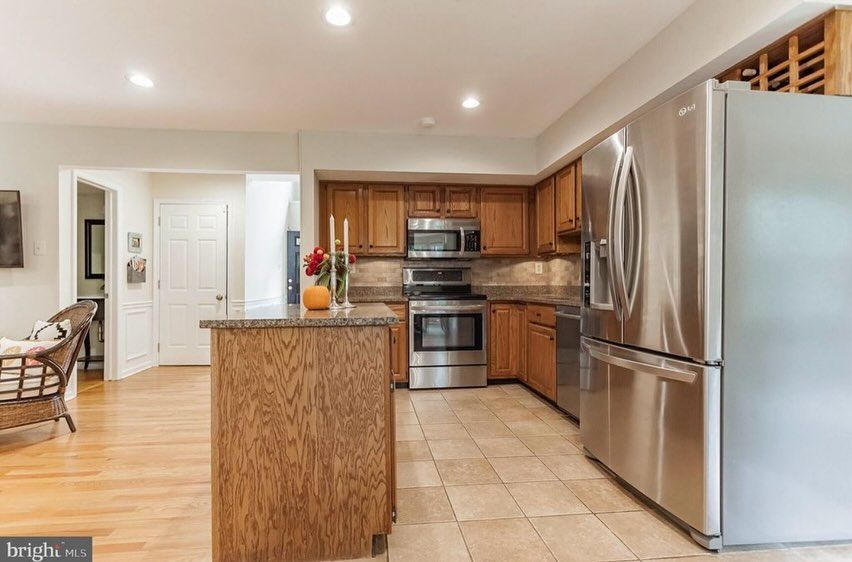 A kitchen with stainless steel appliances and wooden cabinets.