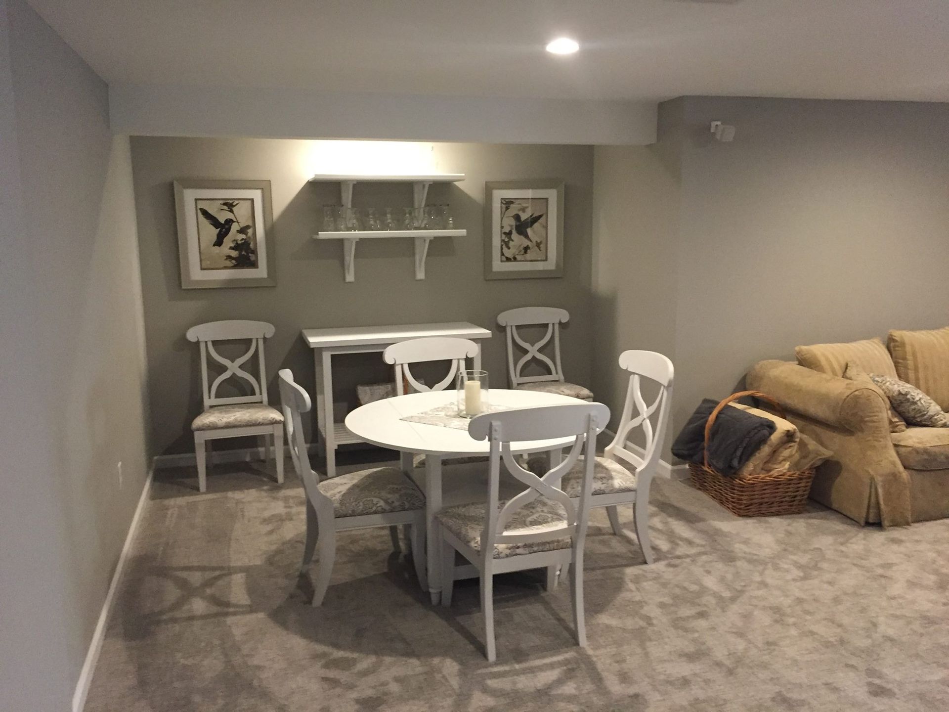 A living room with a table and chairs and a couch.