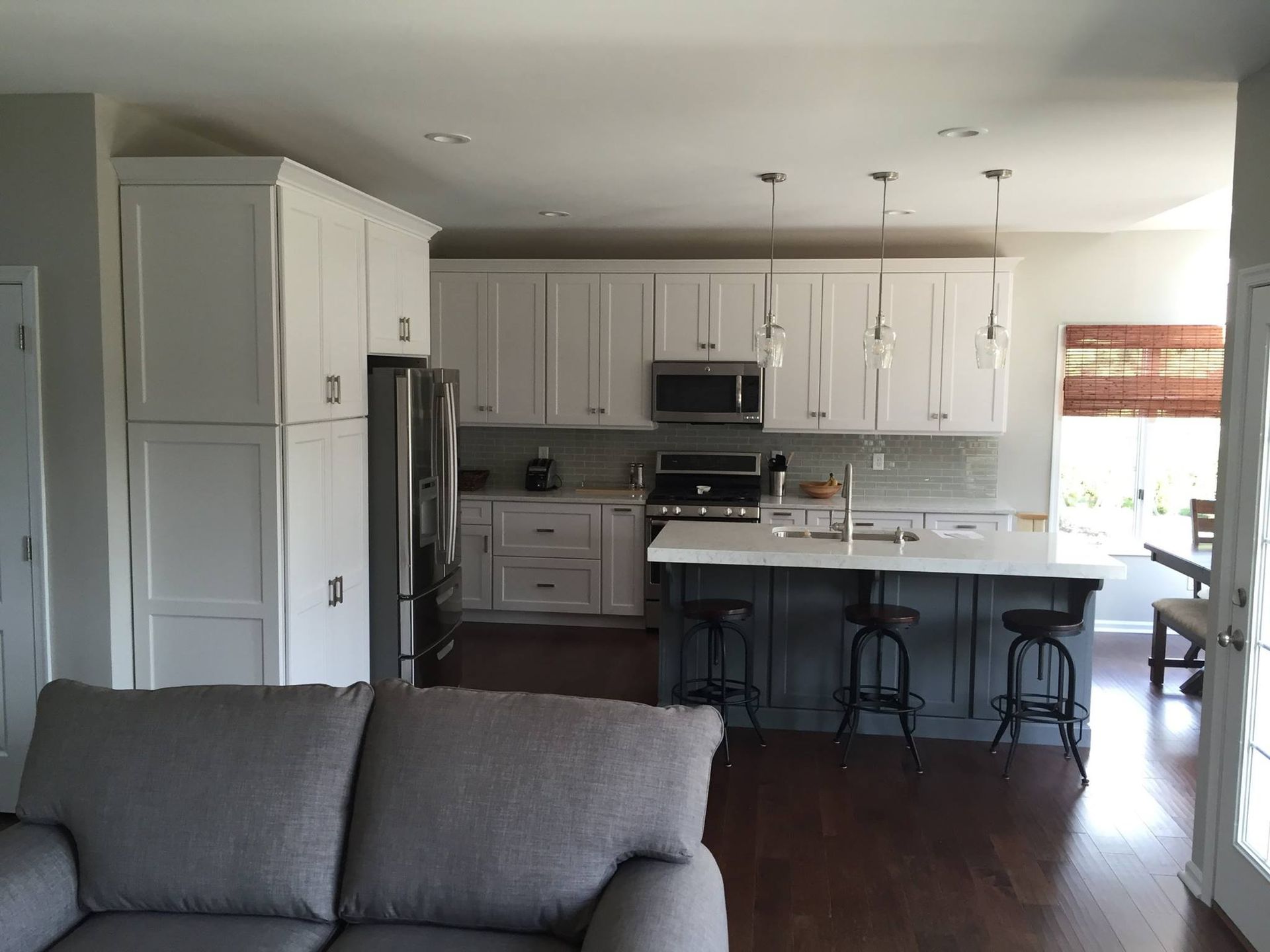 A kitchen with white cabinets and stainless steel appliances