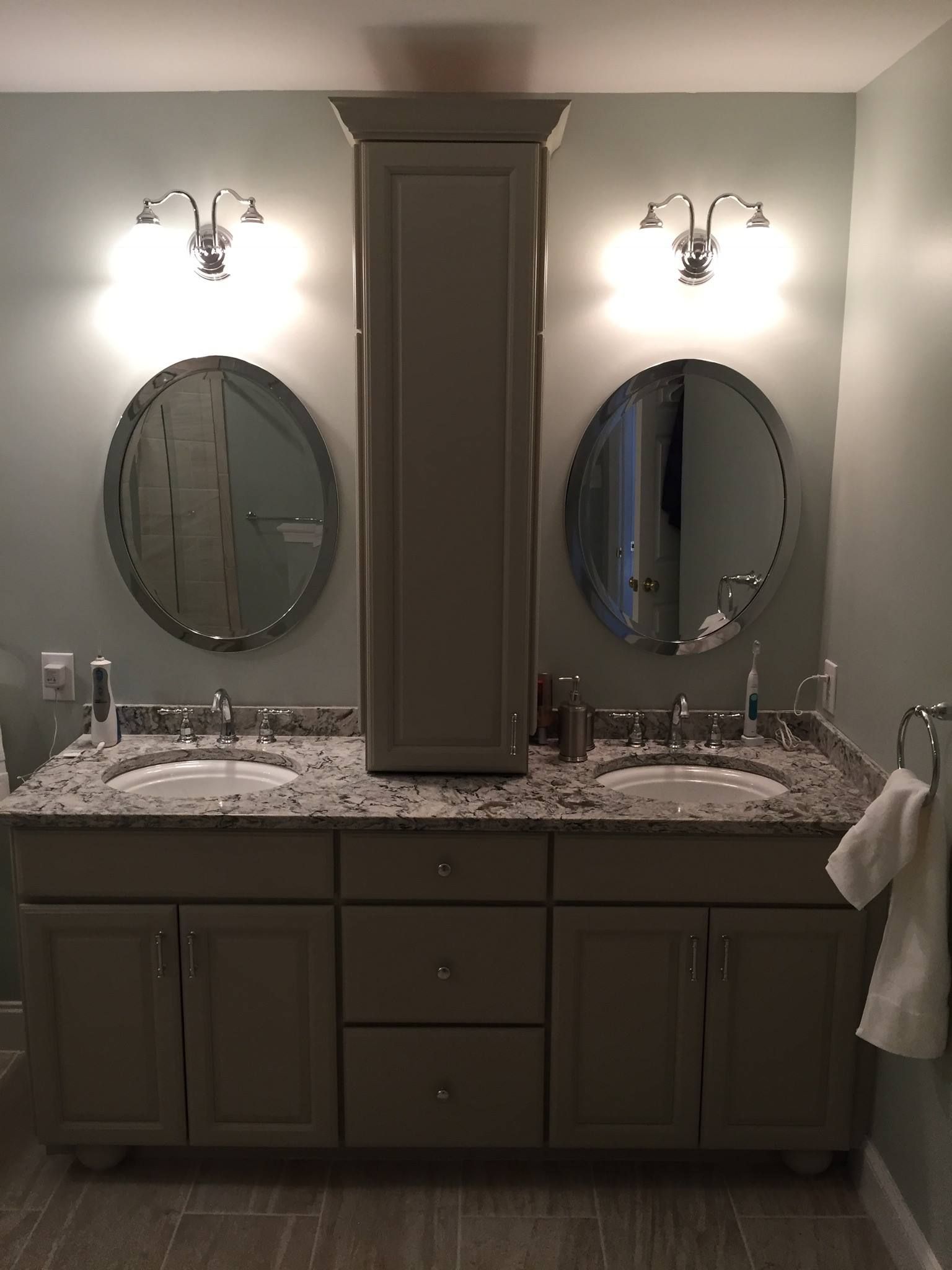 A bathroom with two sinks and two mirrors.