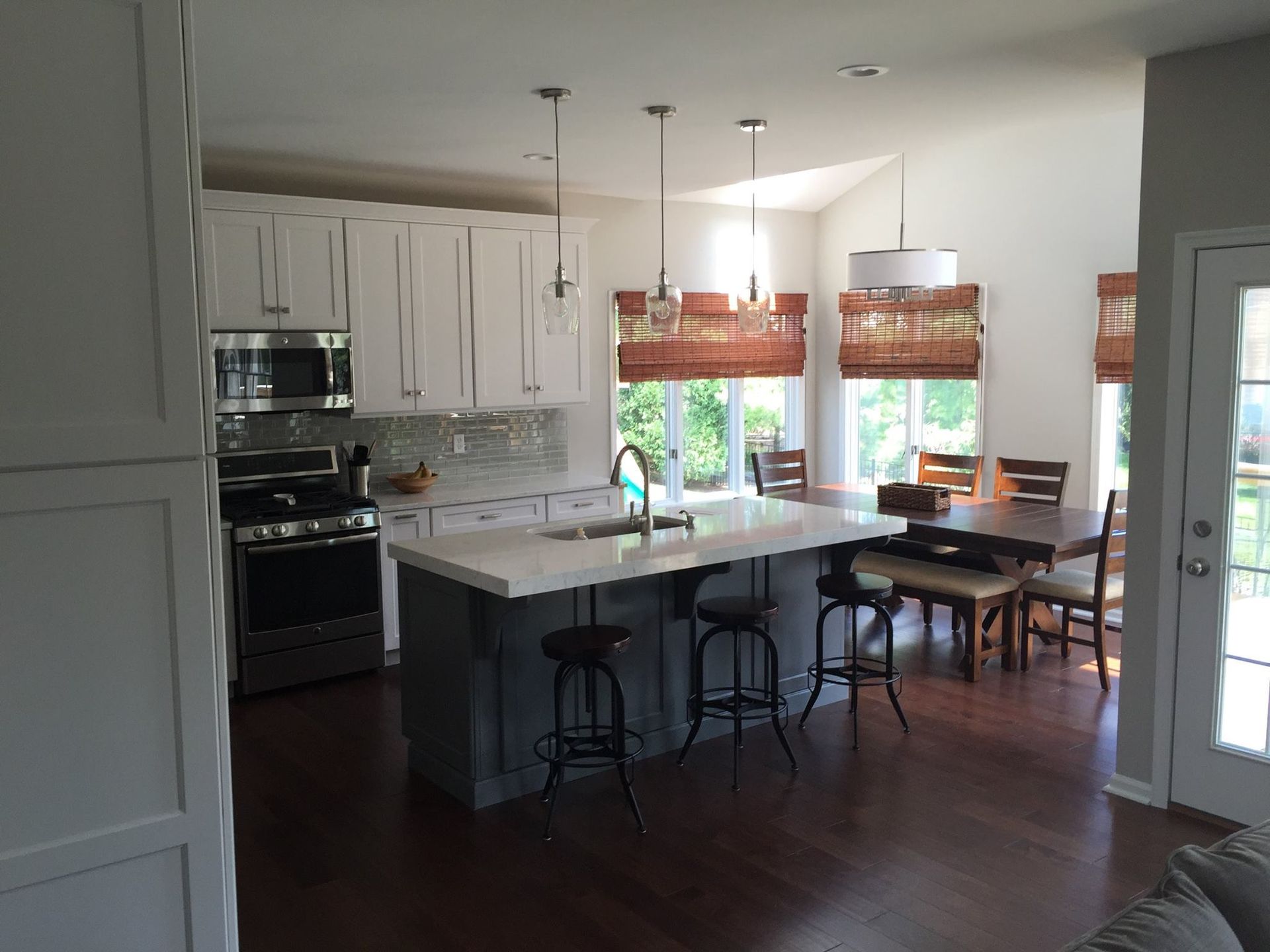 A kitchen with a large island and a dining table