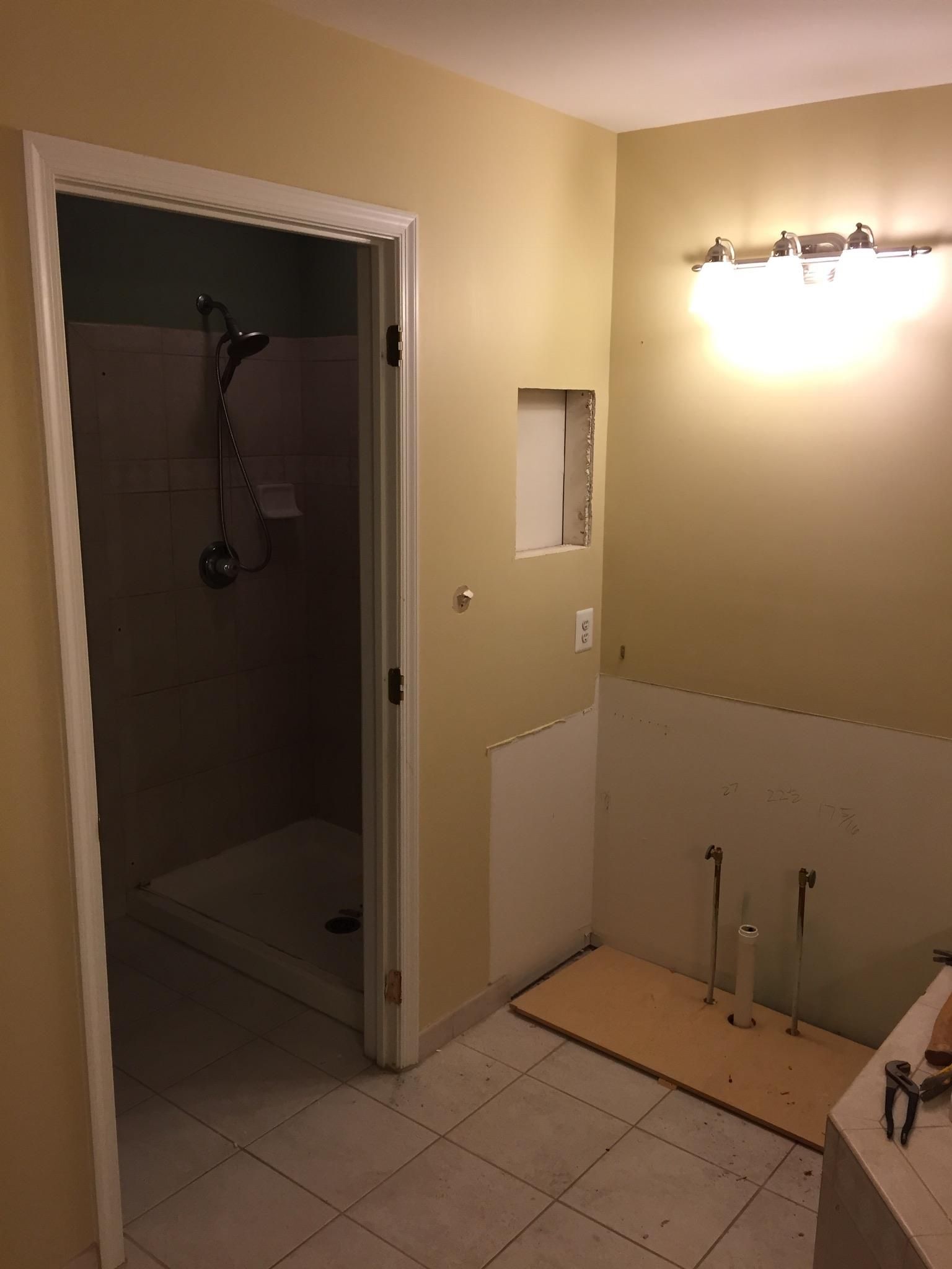 A bathroom with a shower and a sink in it.