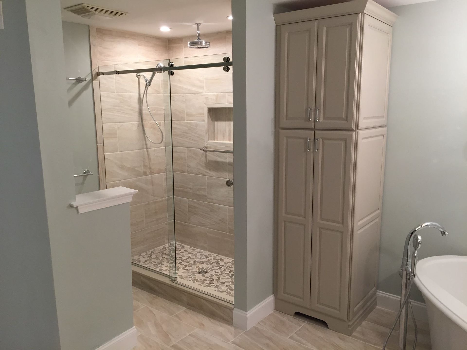 A bathroom with a walk in shower and a bathtub.
