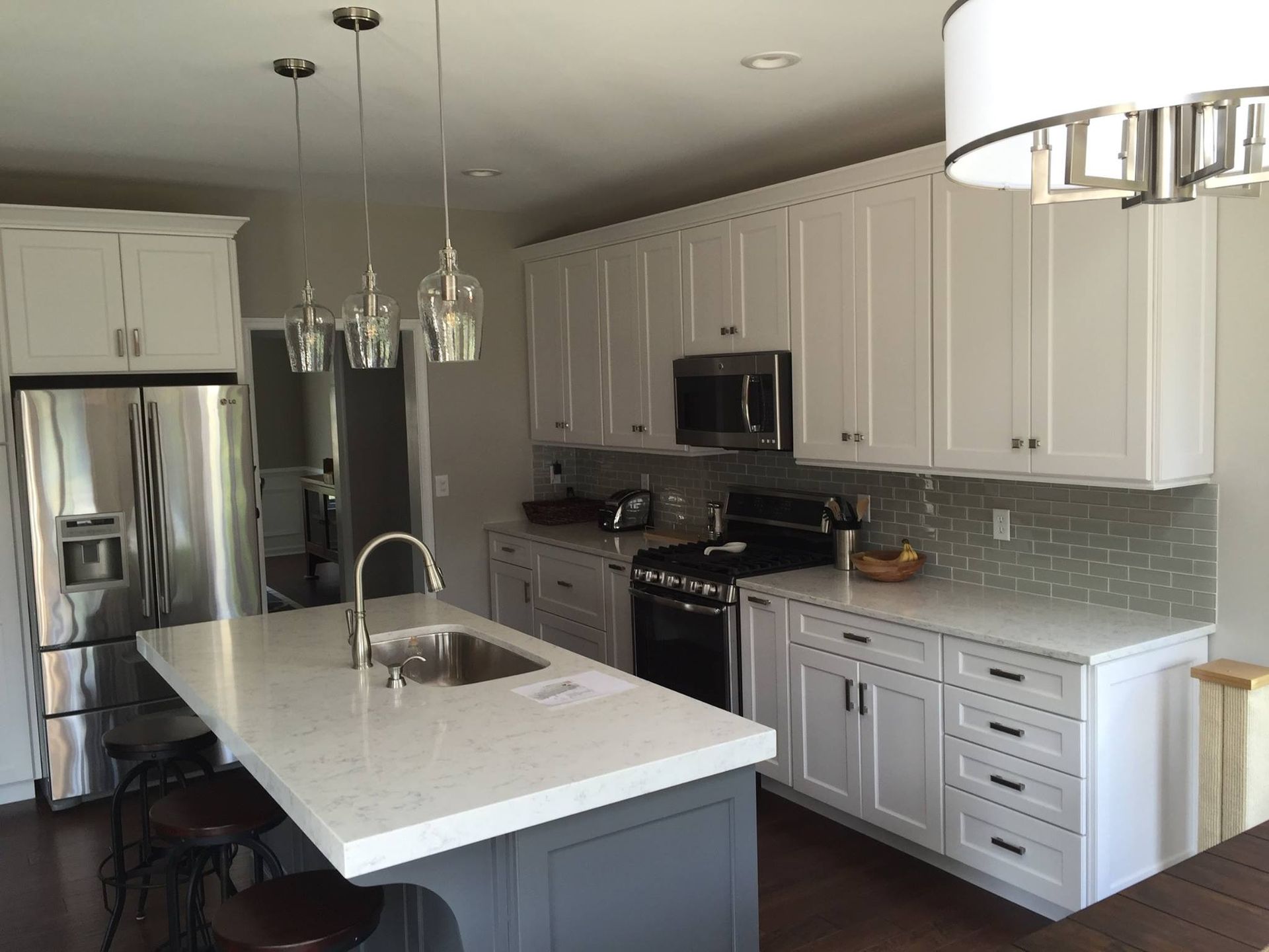 A kitchen with white cabinets and stainless steel appliances