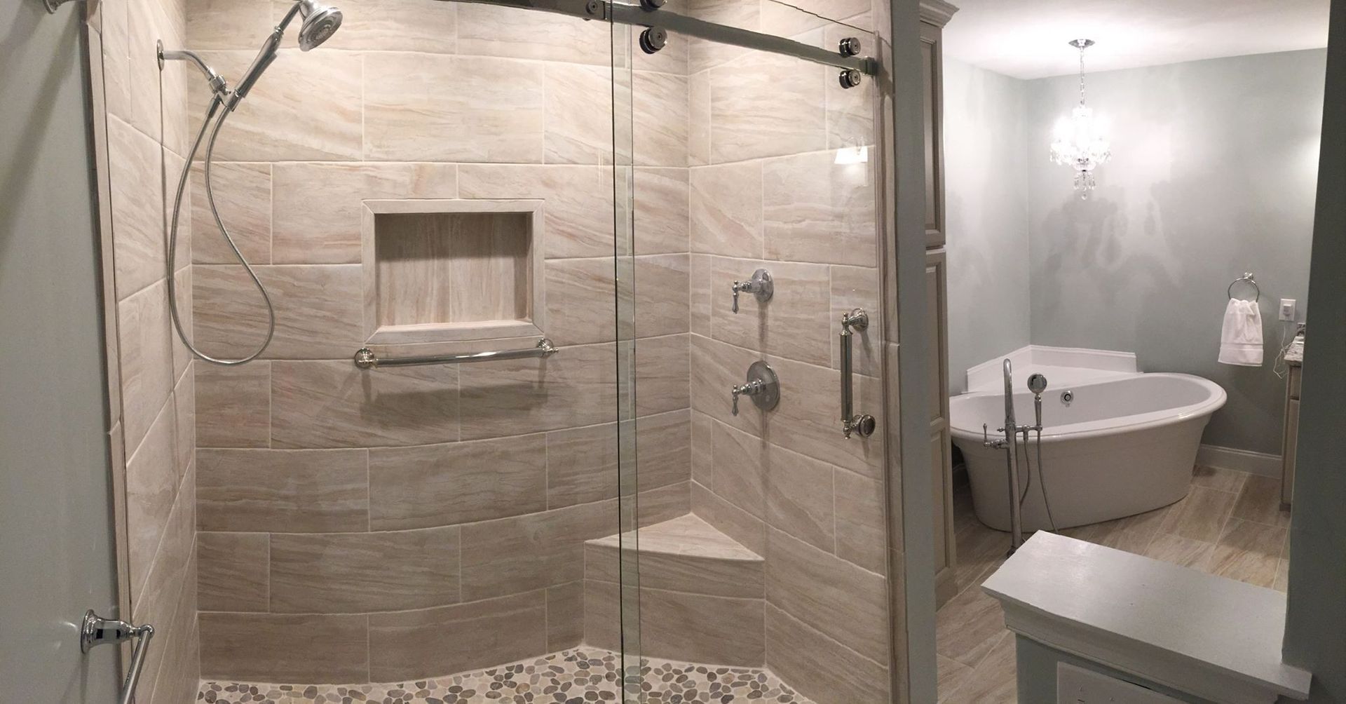 A bathroom with a walk in shower and a bathtub.