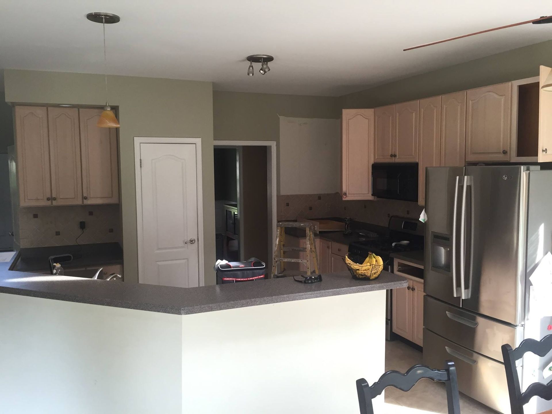 A kitchen with stainless steel appliances and wooden cabinets