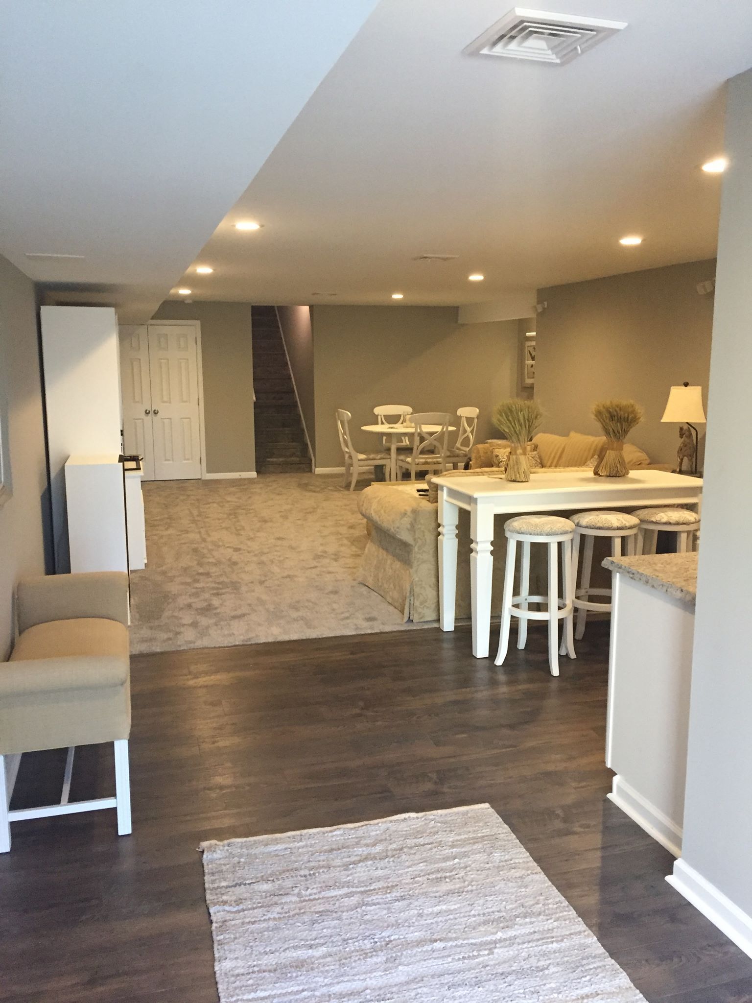 A living room with a table and chairs in it
