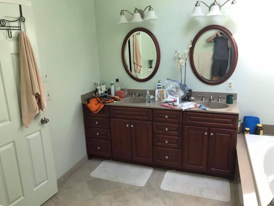 A bathroom with two sinks and two mirrors