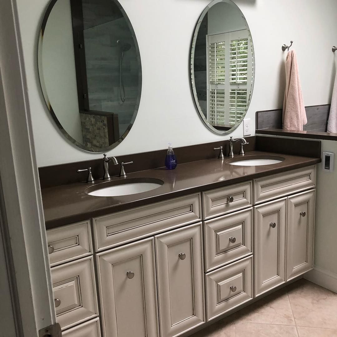 A bathroom with two sinks and two mirrors