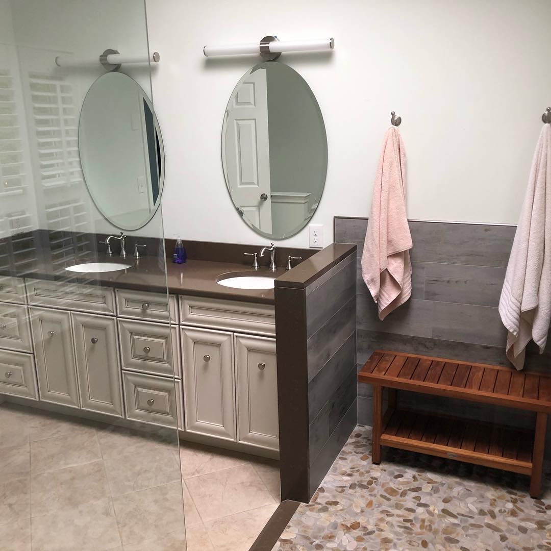 A bathroom with two sinks and two mirrors