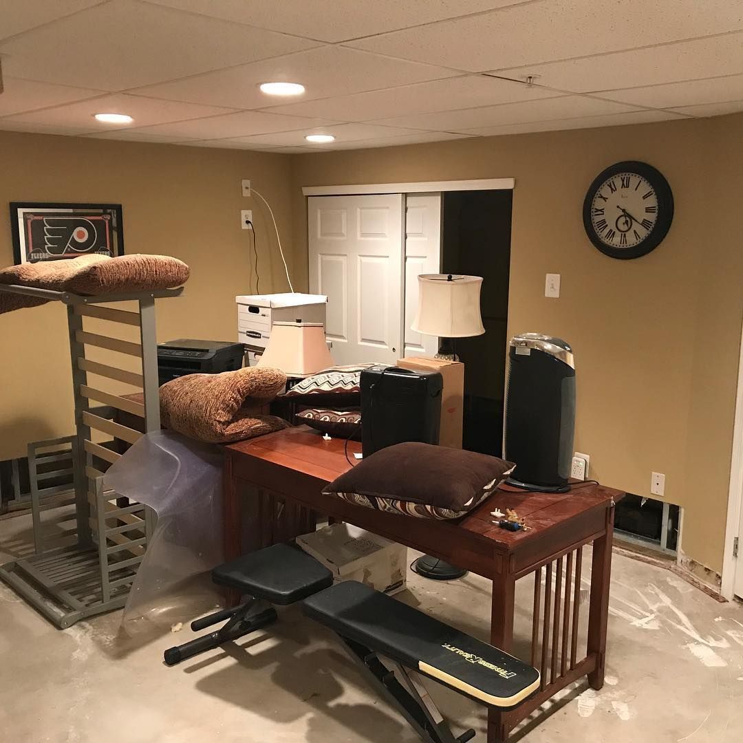 A room with a clock on the wall and a lot of furniture