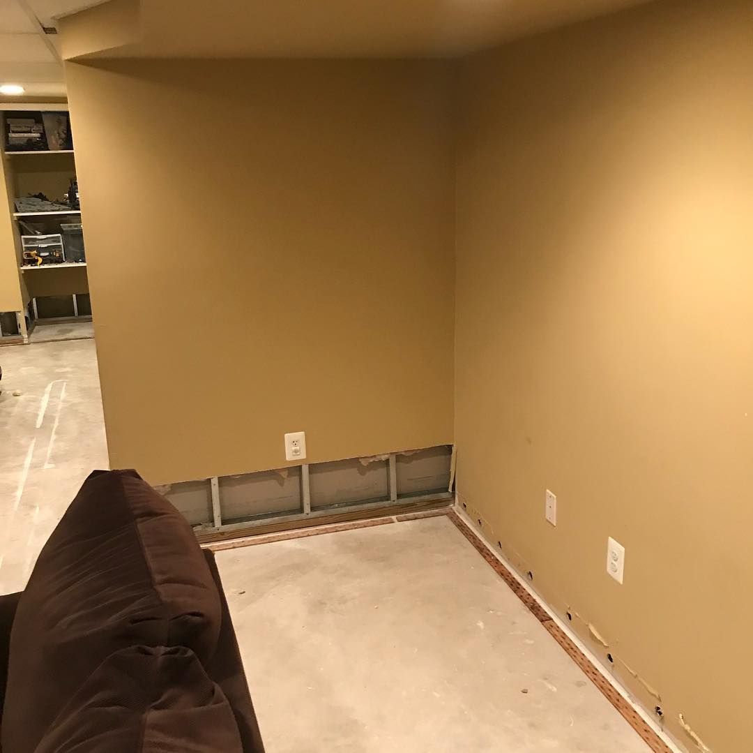 There is a couch in the corner of the room.