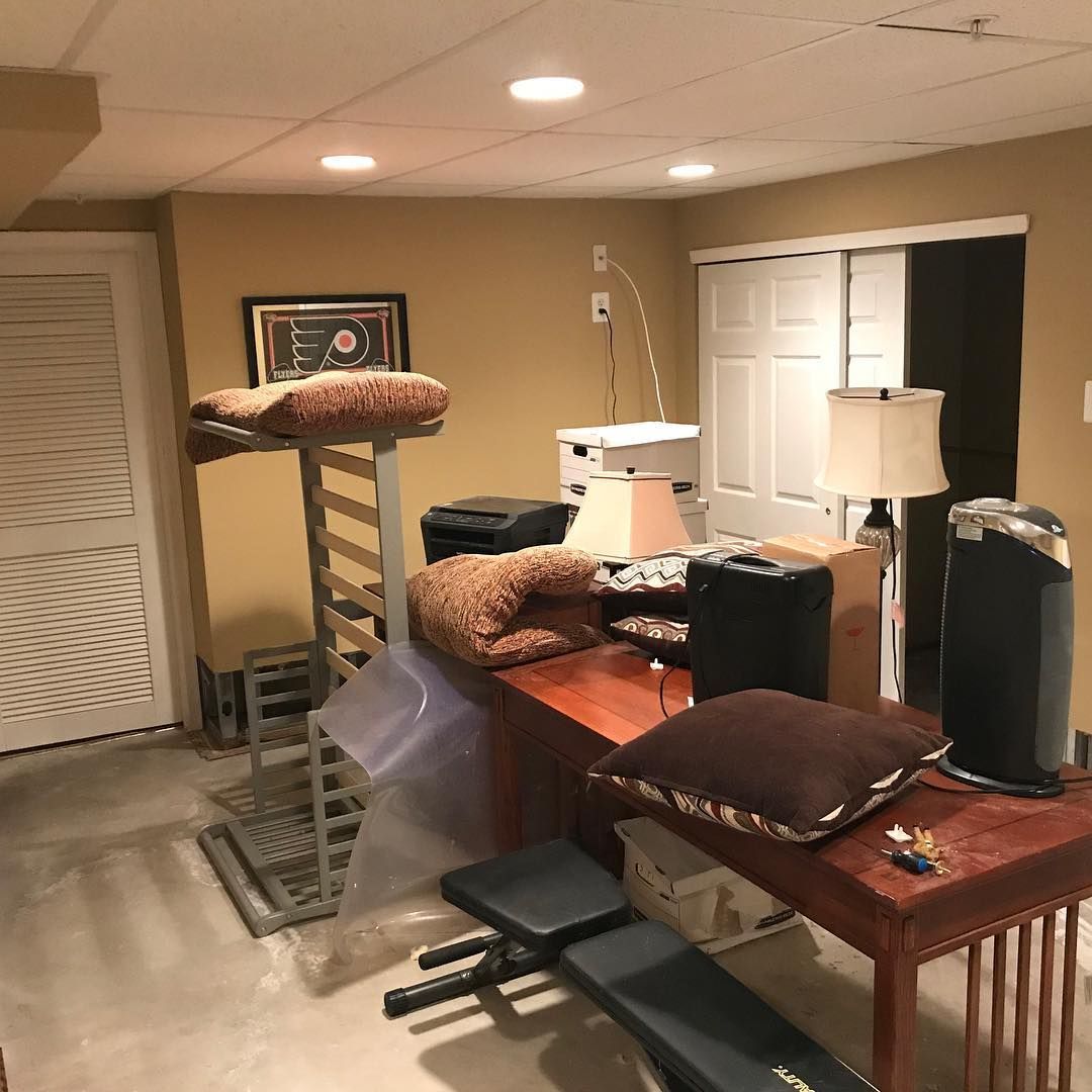 A room with a couch and a table with pillows on it