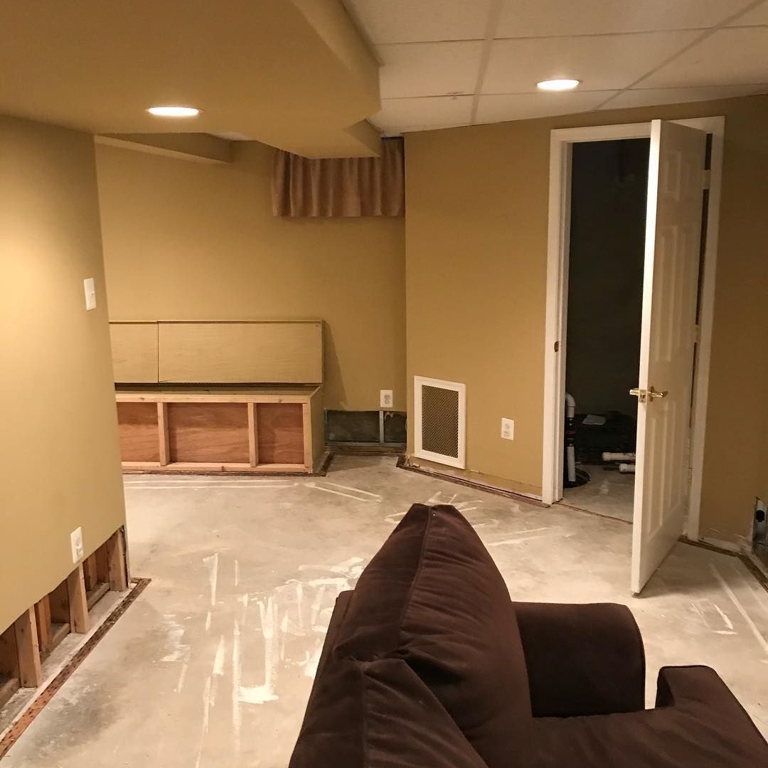 A living room with a brown chair and a brown couch