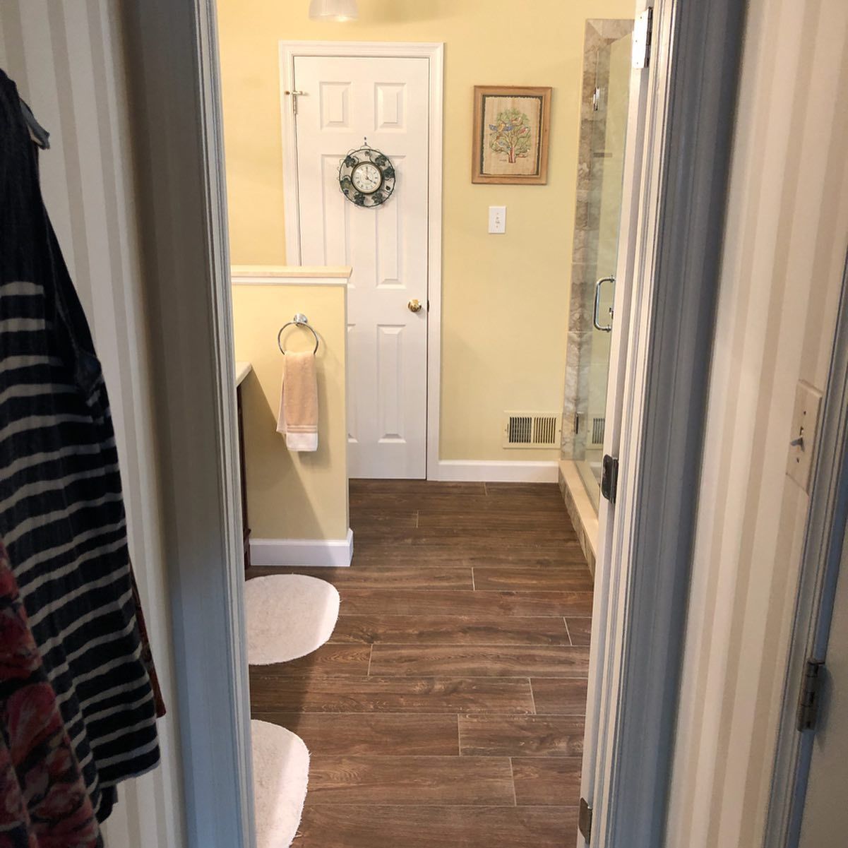 A bathroom with a toilet and a wreath on the door