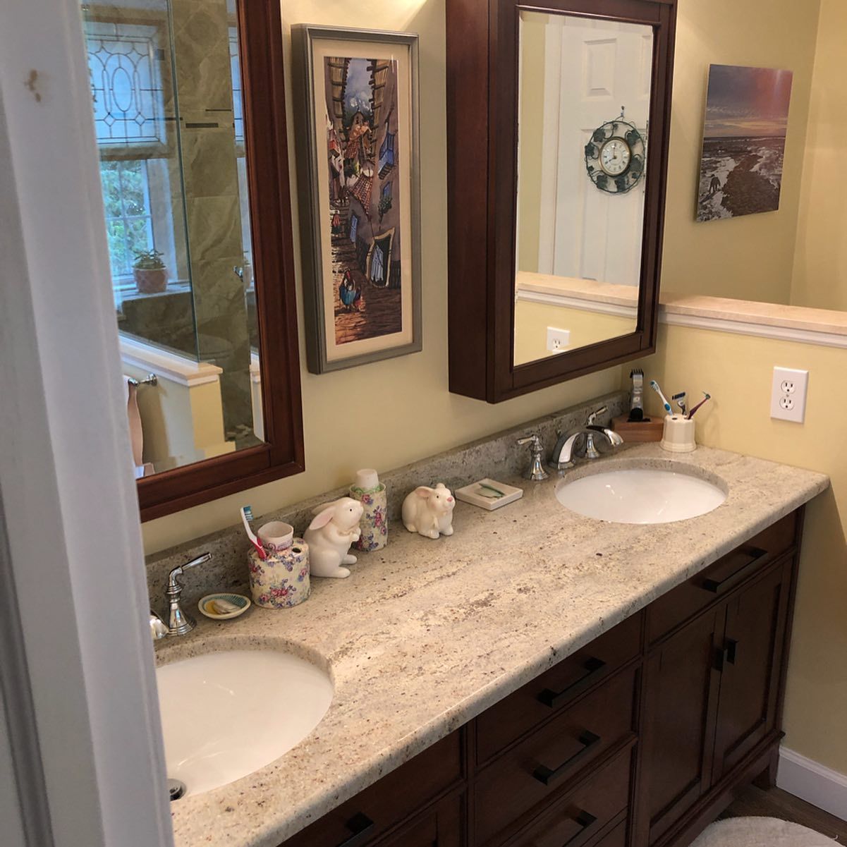 A bathroom with two sinks and two mirrors.