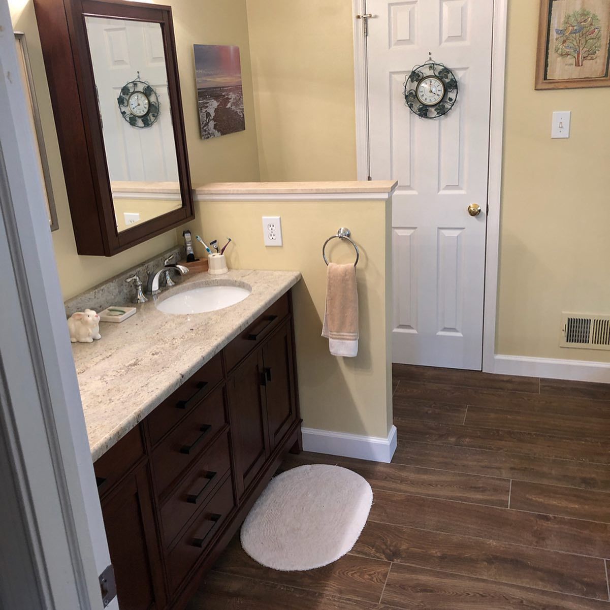 A bathroom with a sink a mirror and a door